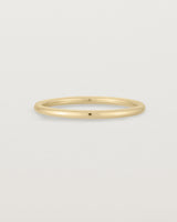 Our fine round wedding band in yellow gold