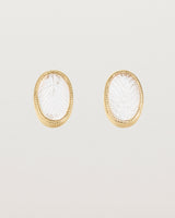 A pair of large oval yellow gold studs featuring carved quartz