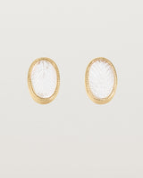 A pair of large oval yellow gold studs featuring carved quartz