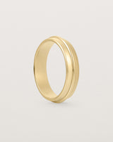 Angled view of the Seam Wedding Ring | 5mm | Yellow Gold