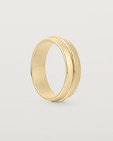 Angled view of the Seam Wedding Ring | 6mm | Yellow  Gold.