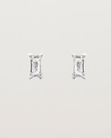 A pair of sterling silver studs featuring an emerald cut white diamond