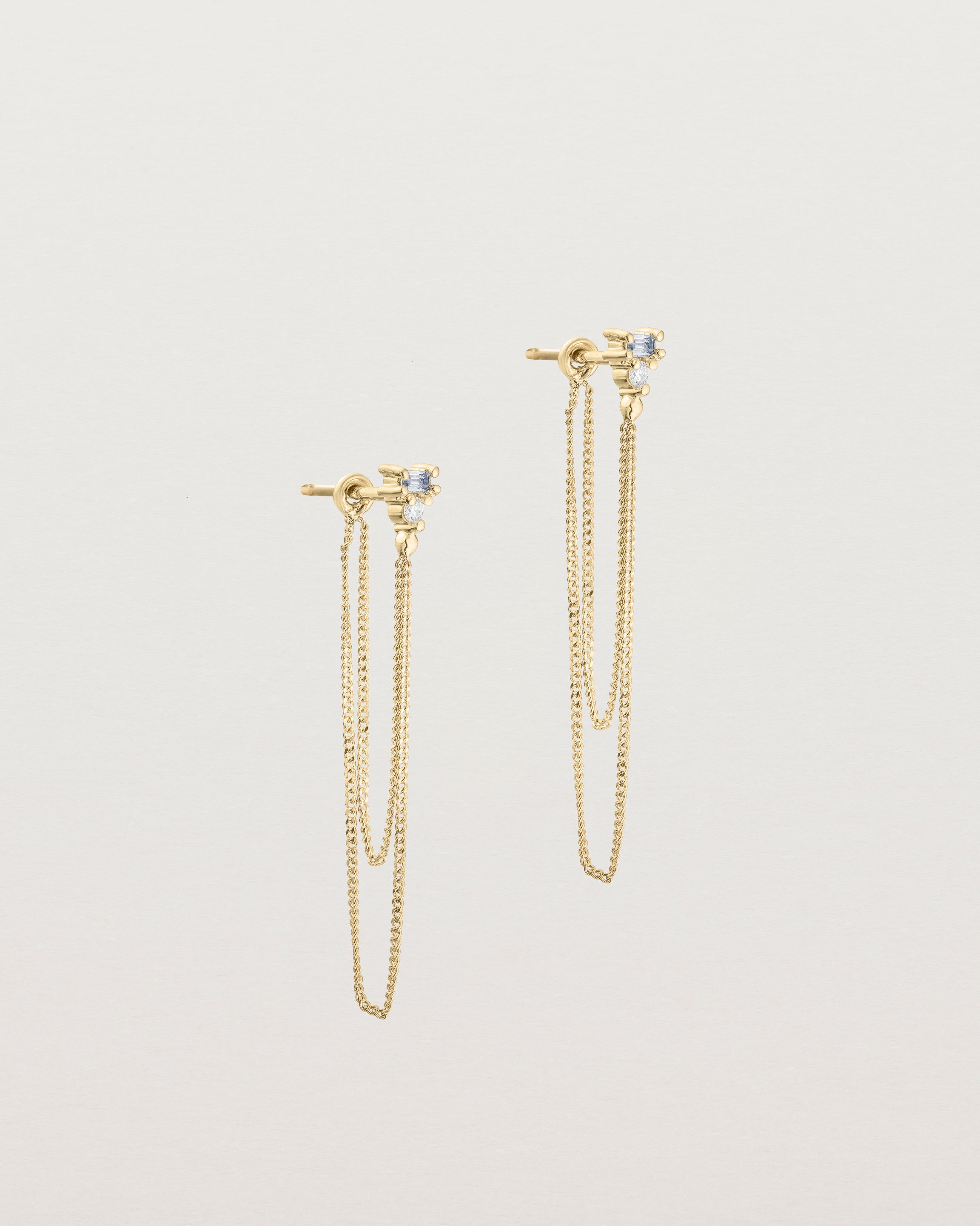 A pair of Sena Loop Studs | Sapphire & Diamond | Yellow Gold.