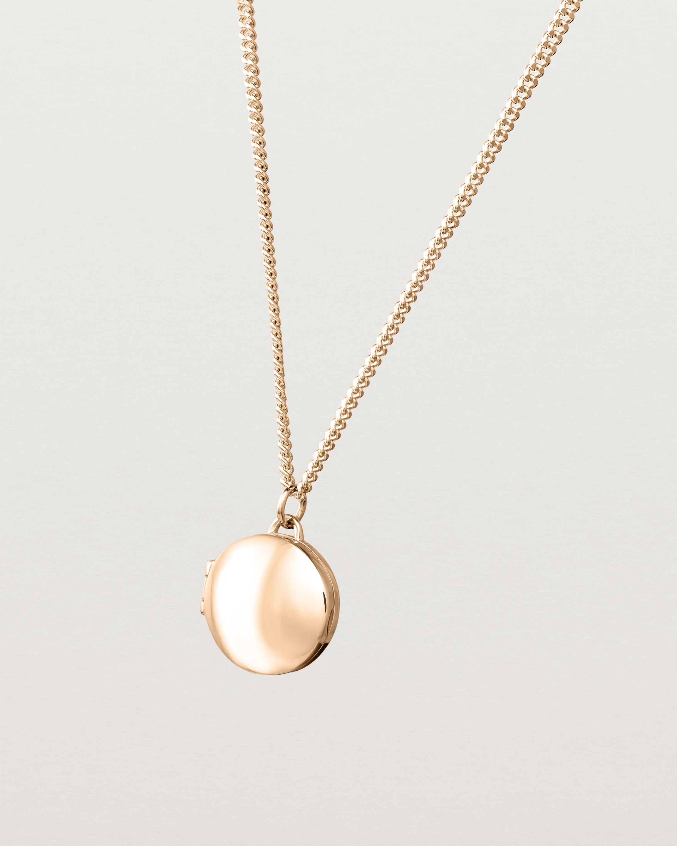 Angled view of the Signature Locket in rose gold.