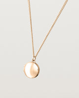 Angled view of the Signature Locket in rose gold.