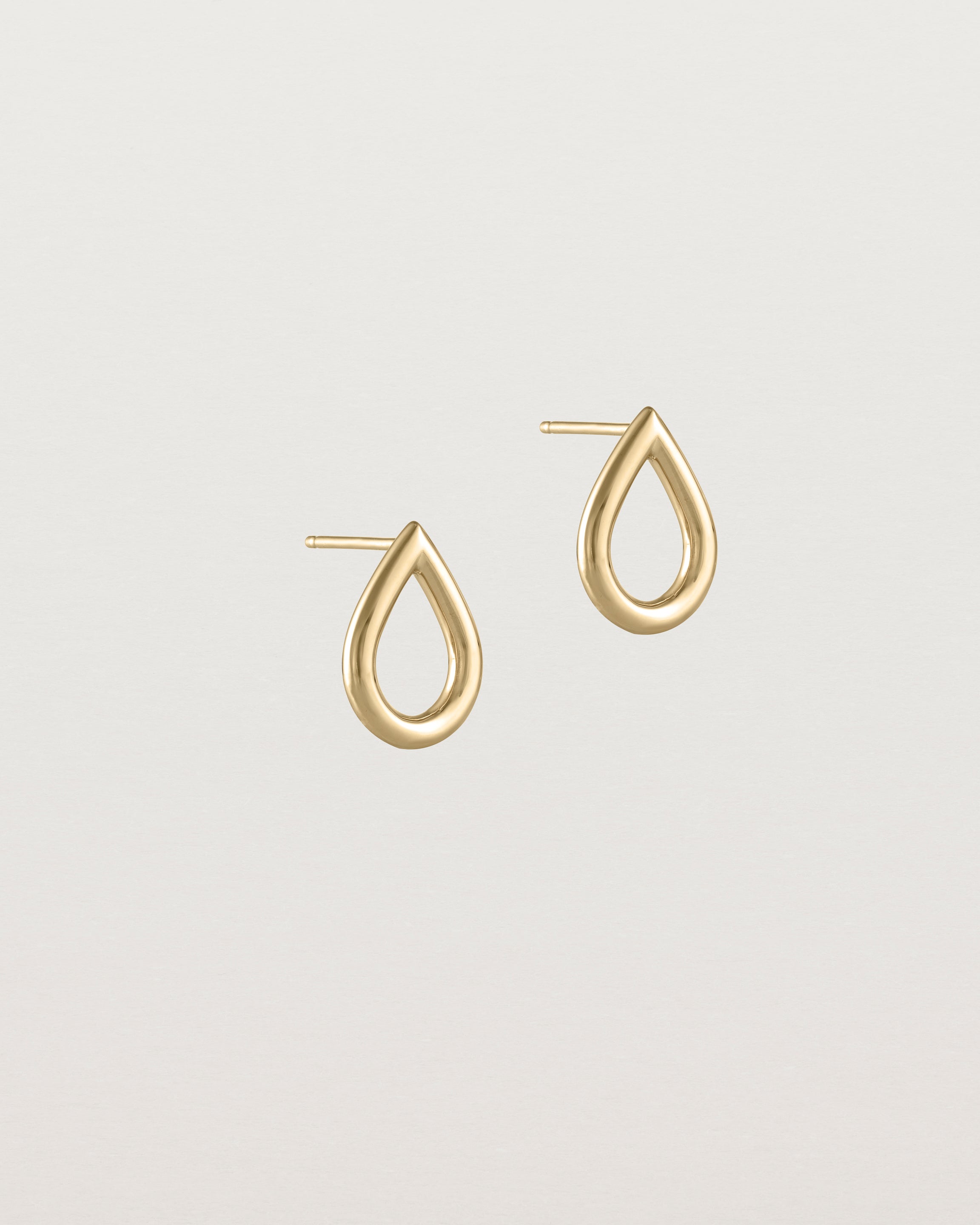 Angled view of the Small Dena Studs in yellow gold.