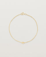top view of Sonder bracelet in yellow gold showing one charm