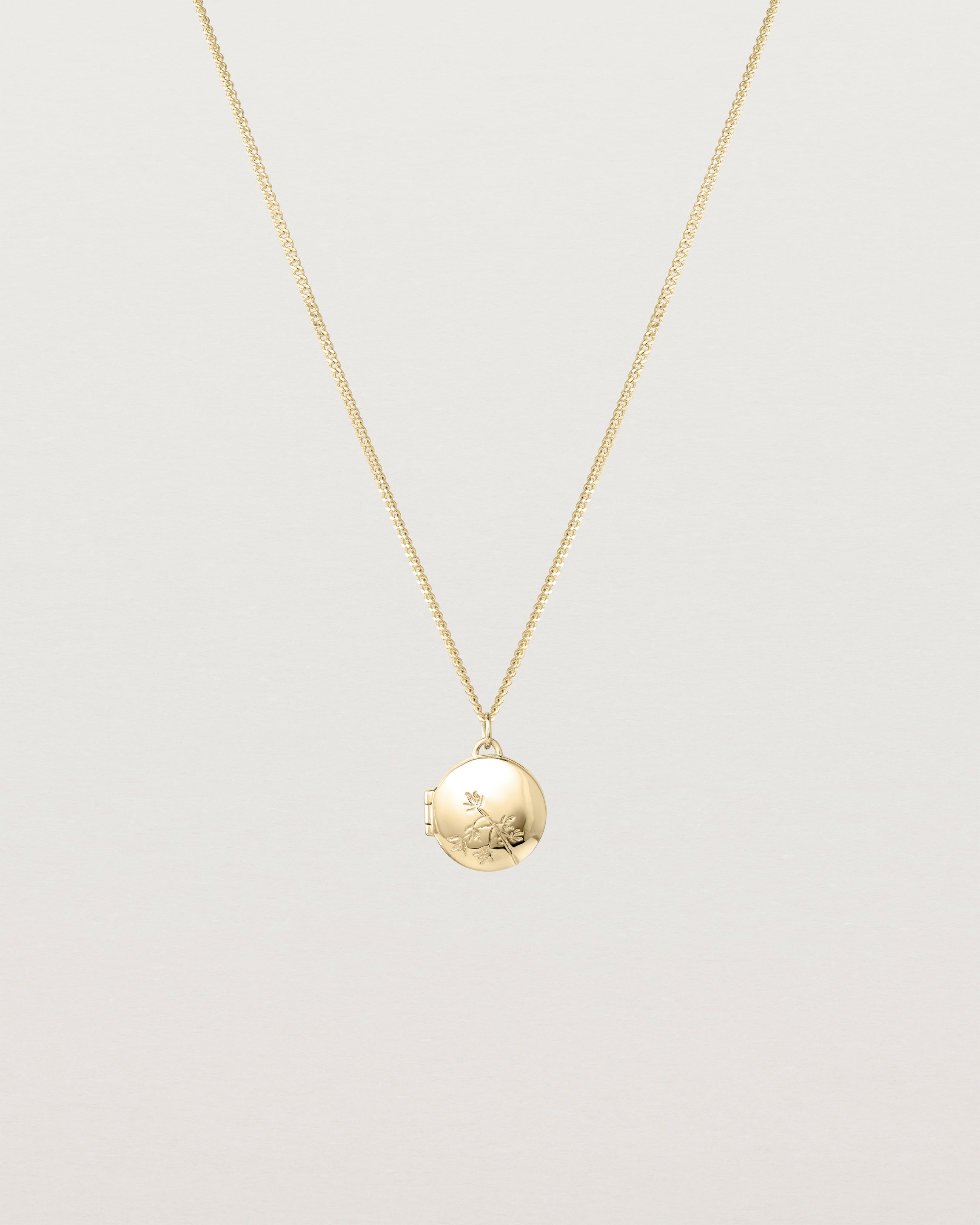 Front view of the Spotted Orchid Locket in yellow gold.