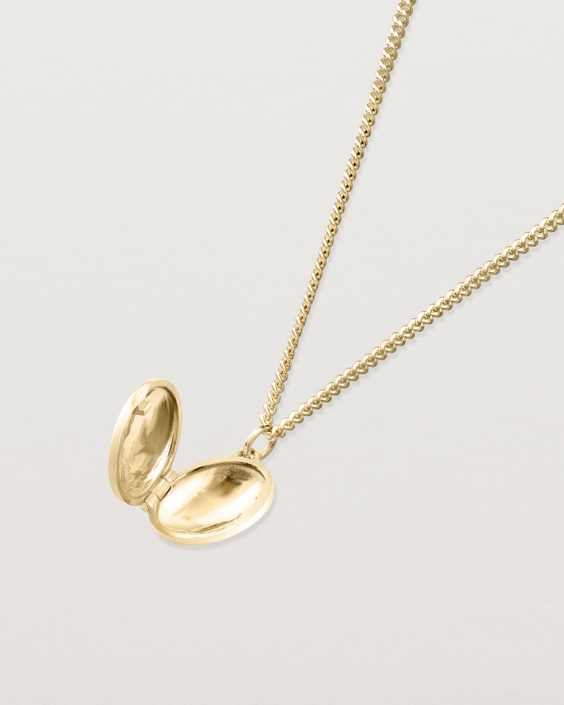Open view of the Spotted Orchid Locket in yellow gold.