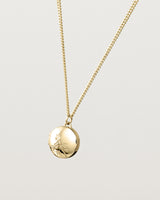 Angled view of the Spotted Orchid Locket in yellow gold.