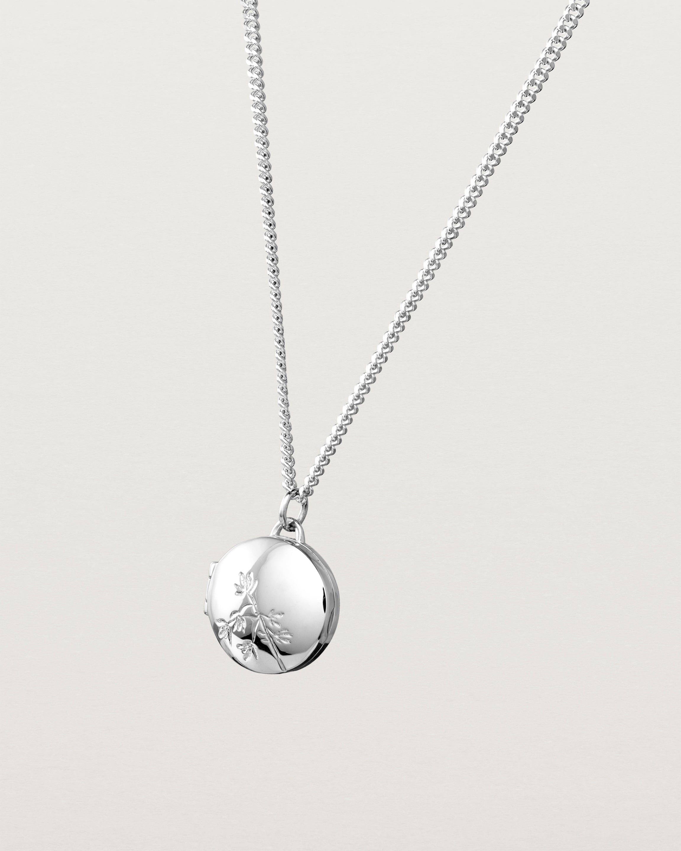 Angled view of the Spotted Orchid Locket in sterling silver.