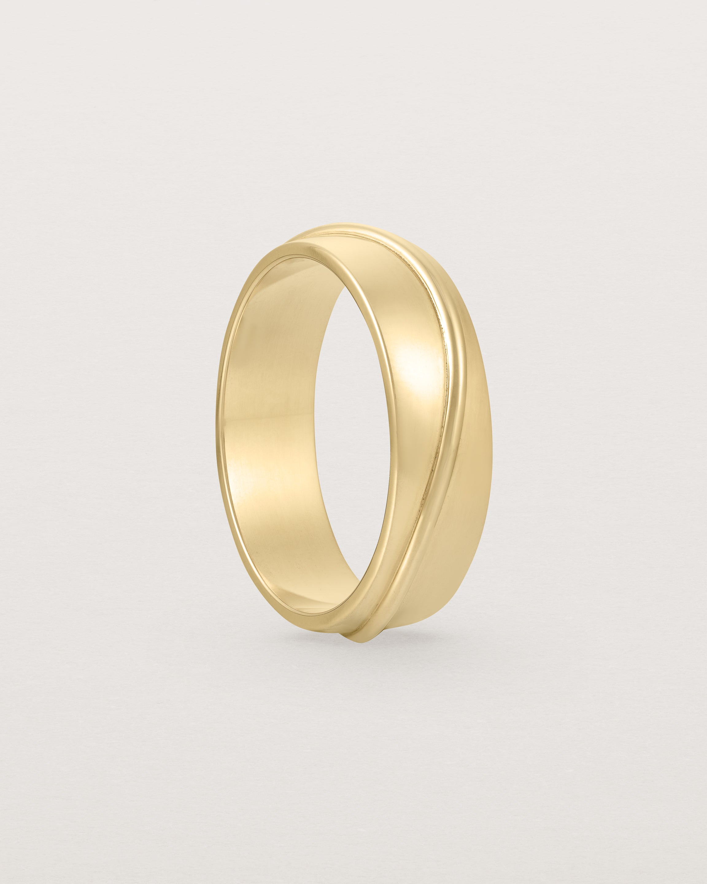 Standing view of the Surge Wedding Ring | 6mm | Yellow Gold.
