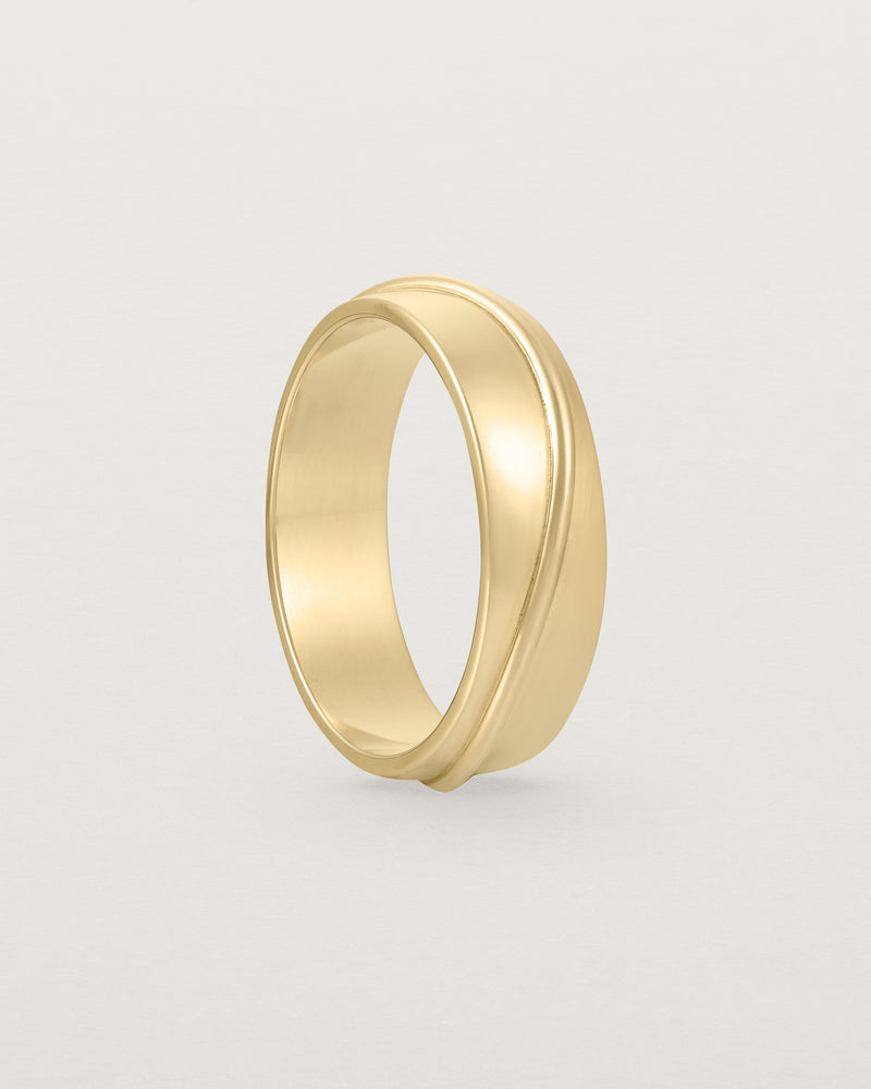 Standing view of the Surge Wedding Ring | 6mm | Yellow Gold.