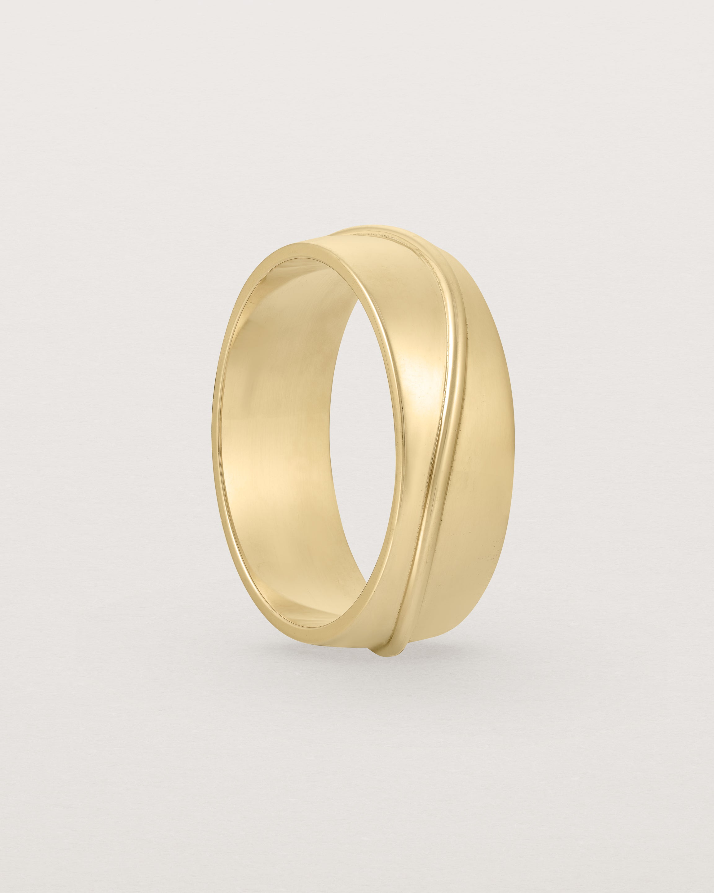 Standing view of the Surge Wedding Ring | 7mm | Yellow Gold.