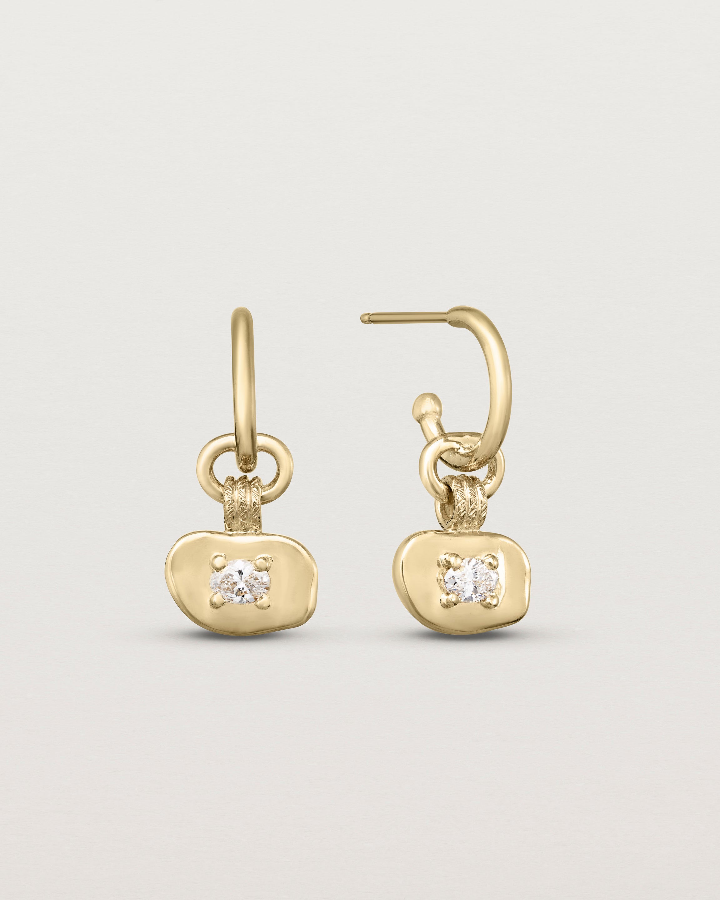 A pair of Terra Hoops | Diamond in yellow gold.