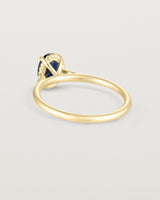 A back view of the Thea Oval Solitaire with a deep blue Australian Sapphire in Yellow Gold