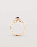 A side profile of the Thea Oval Solitaire with a dark blue Australian Sapphire in Rose Gold. 