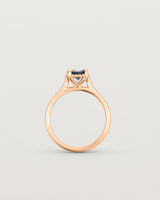 A side profile of the Thea Round Solitaire with a deep blue Australian Sapphire in Rose Gold
