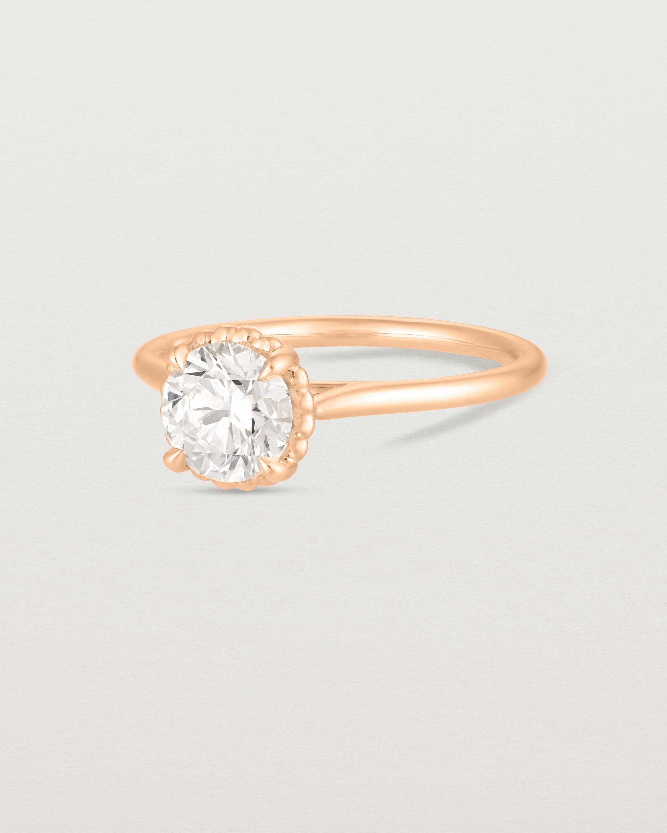 A side view of the Thea Round Solitaire with a white Laboratory Grown Diamond in Rose Gold