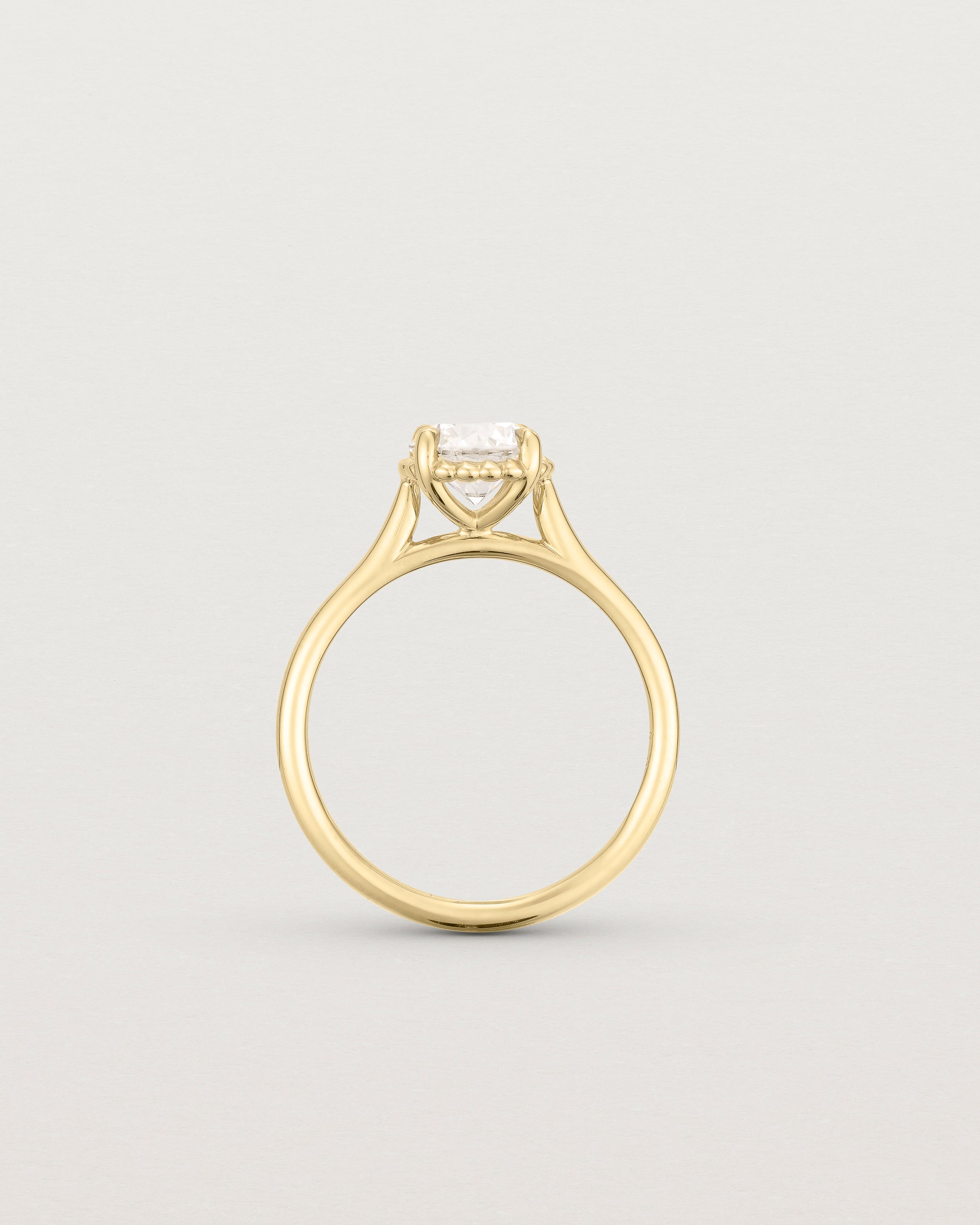 A side profile of the Thea Round Solitaire with a white Laboratory Grown Diamond in Yellow Gold