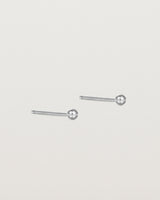 A pair of tiny sterling silver studs featuring a round ball