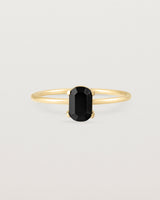 Fine yellow gold band featuring an oval black spinel stone