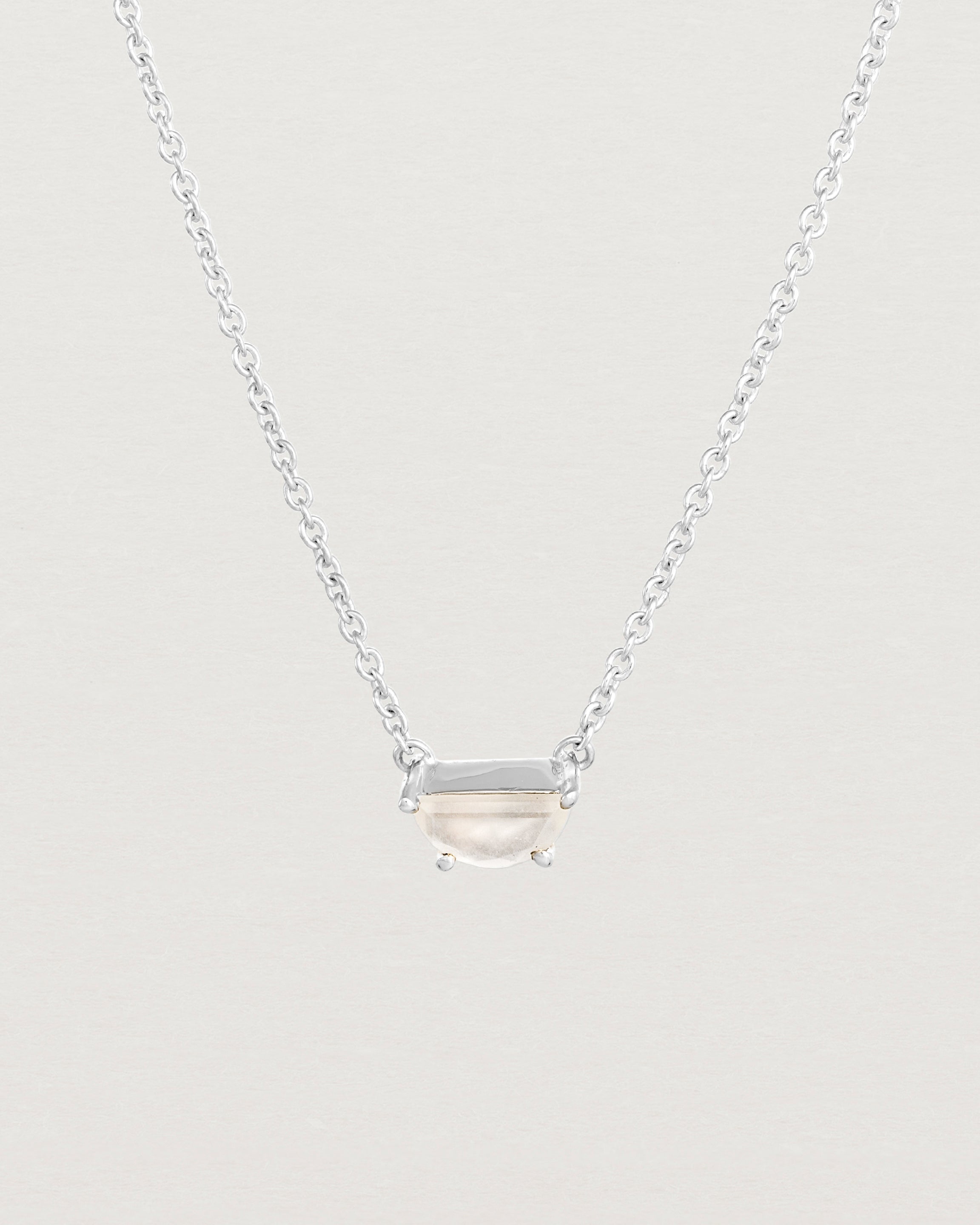 Close up view of the Tiny Half Moon Pendant | Moonstone in sterling silver.