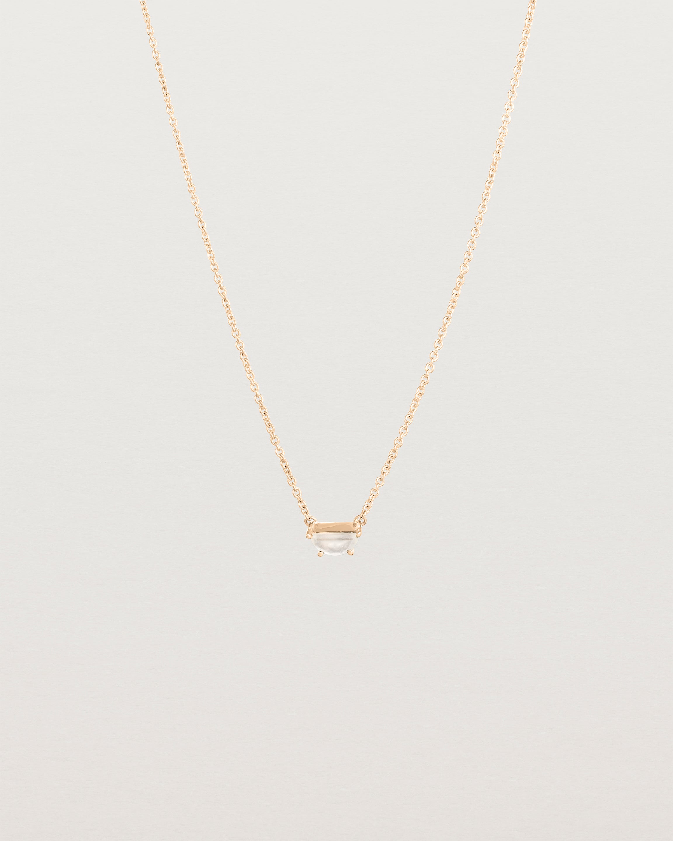 Front view of the Tiny Half Moon Pendant | Moonstone in rose gold.