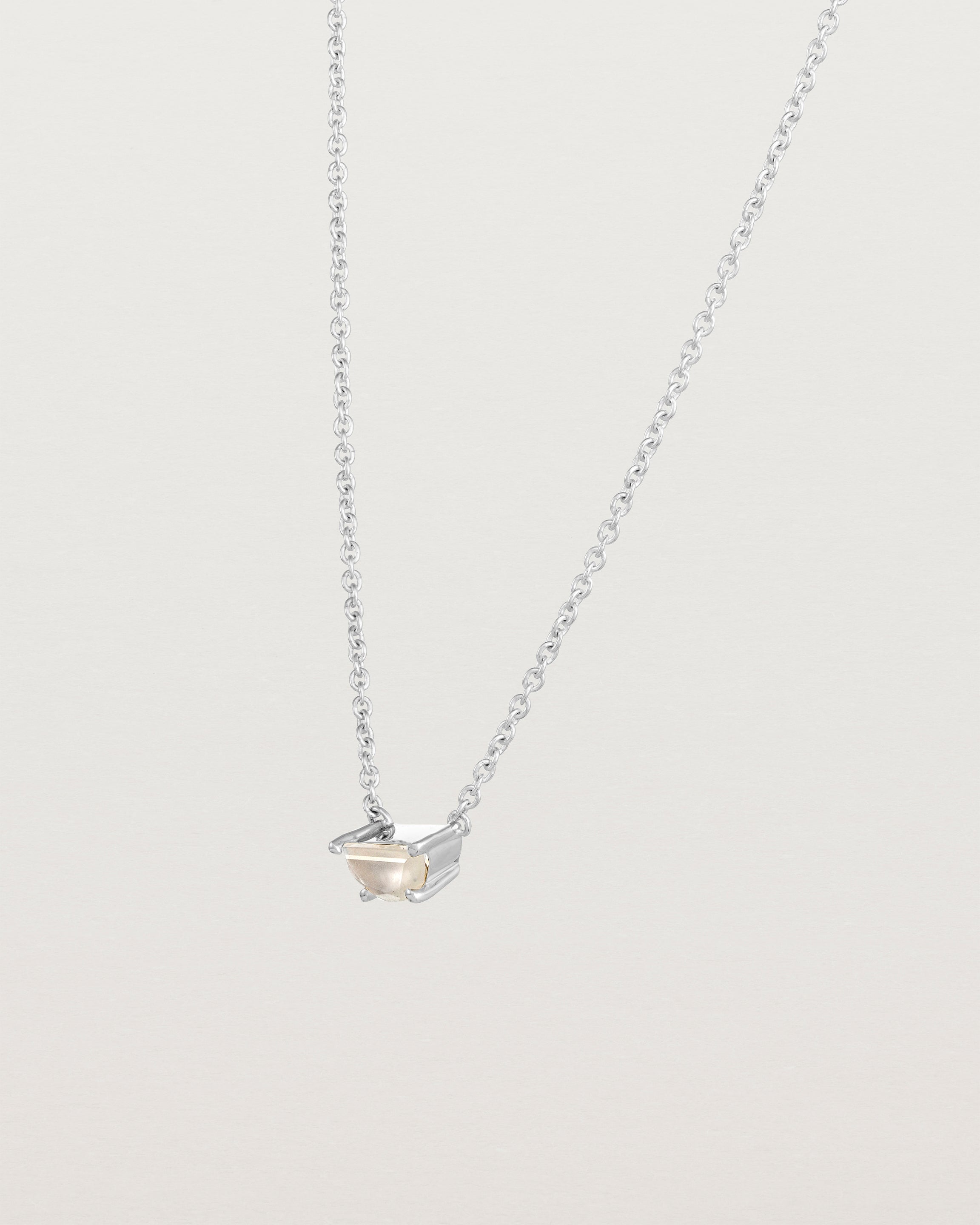Angled view of the Tiny Half Moon Pendant | Moonstone in sterling silver.