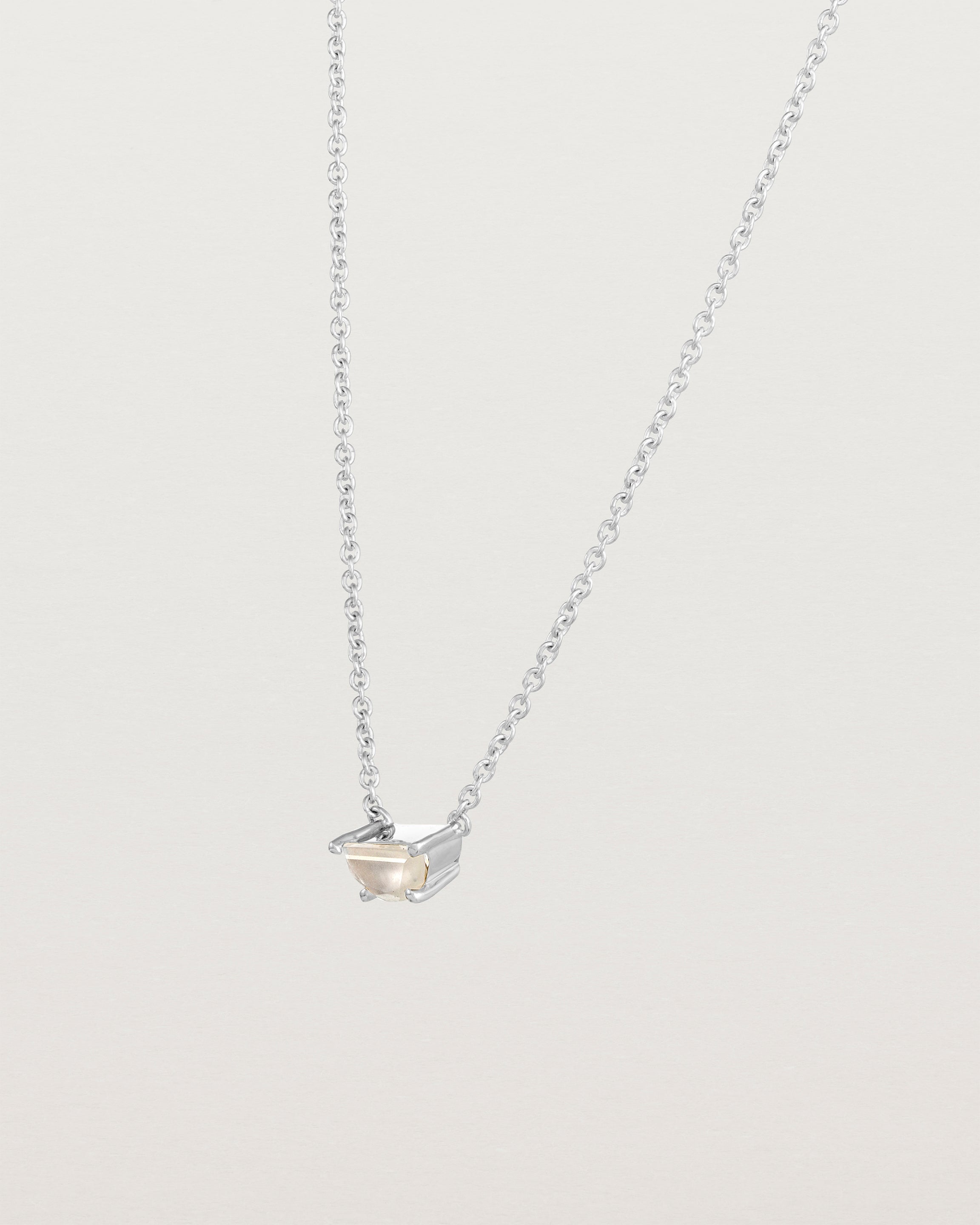 Angled view of the Tiny Half Moon Pendant | Moonstone in sterling silver.