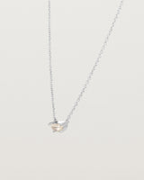 Angled view of the Tiny Half Moon Pendant | Moonstone in sterling silver.