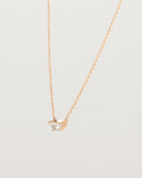 Angled view of the Tiny Half Moon Pendant | Moonstone in rose gold.