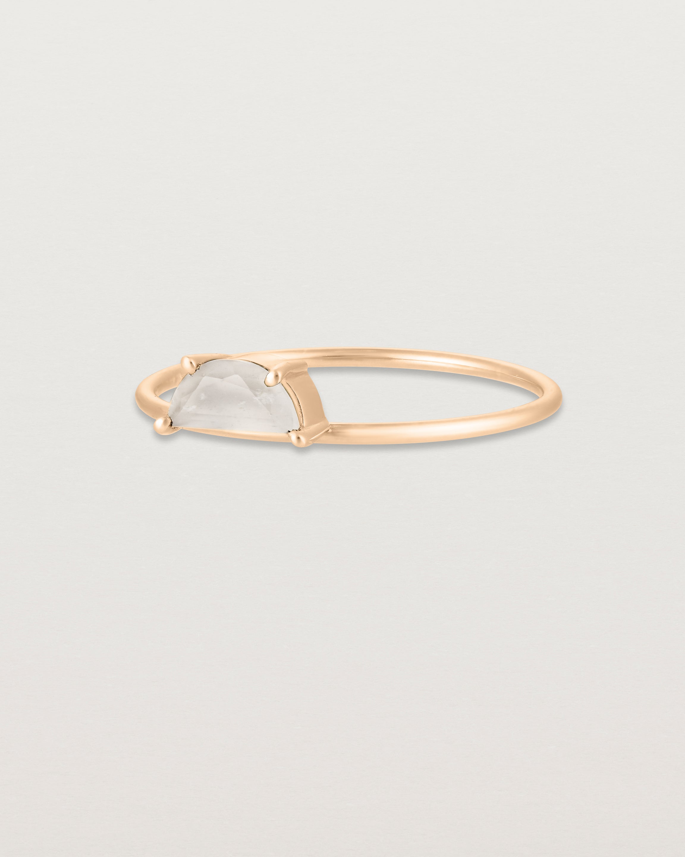 Angled view of the Tiny Half Moon Ring | Moonstone in rose gold.