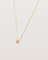 Angled view of the Tiny Marquise Necklace with Rutilated Quartz in yellow gold.