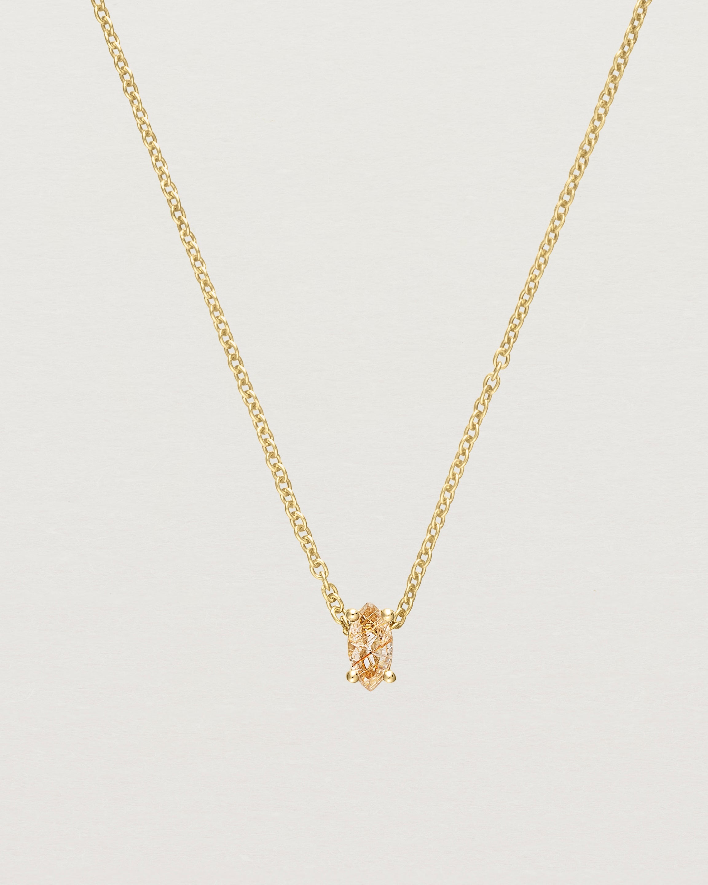 Close up of the Tiny Marquise Necklace with Rutilated Quartz in yellow gold.