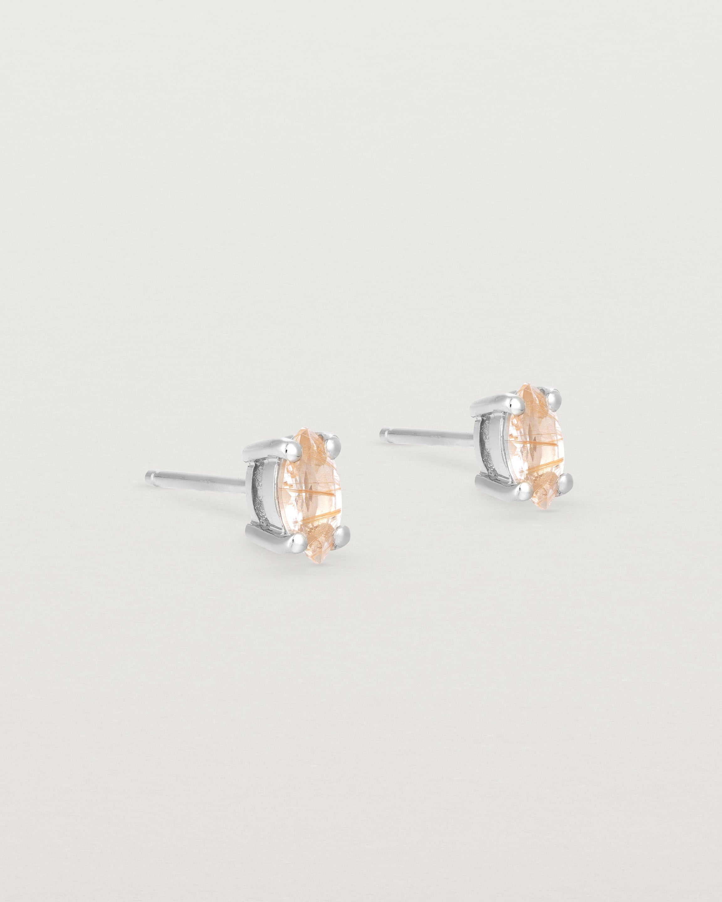 A pair of sterling silver studs featuring a marquise shaped light yellow rutilated quartz