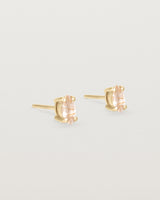 A pair of yellow gold studs featuring a marquise shaped light yellow rutilated quartz