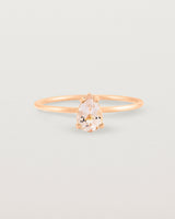 A fine rose gold ring featuring a pear shaped pink morganite stone