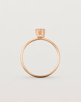 A fine rose gold ring featuring a pear shaped pink morganite stone