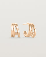 Front view of a pair of Triple Reliquum Hoops in rose gold.