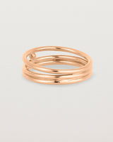 layered rose gold ring featuring a yellow gold ball suspended between two bands