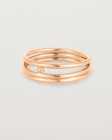 layered rose gold ring featuring a yellow gold ball suspended between two bands