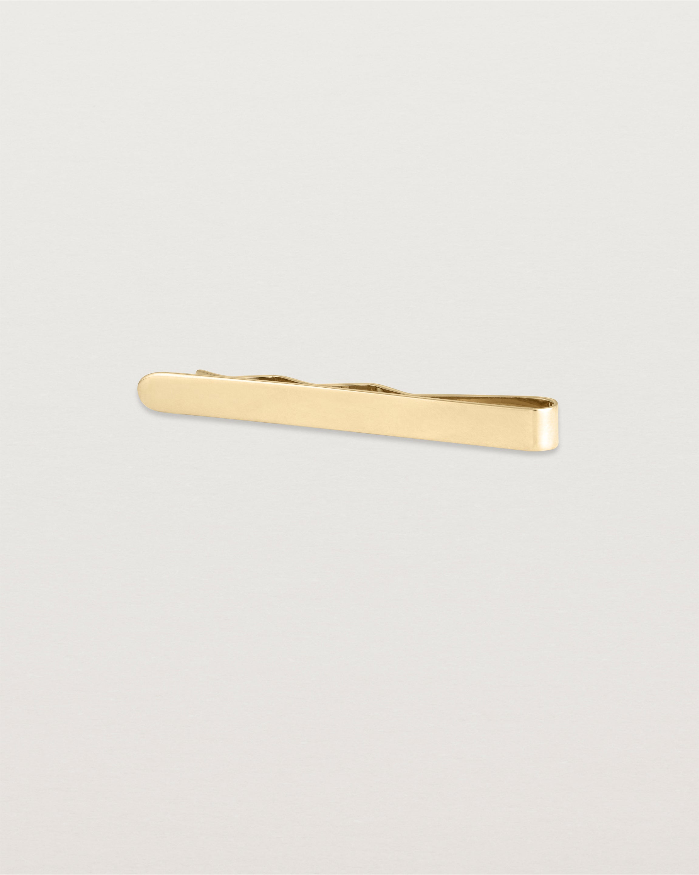 The Turas Tie Bar in Yellow Gold.