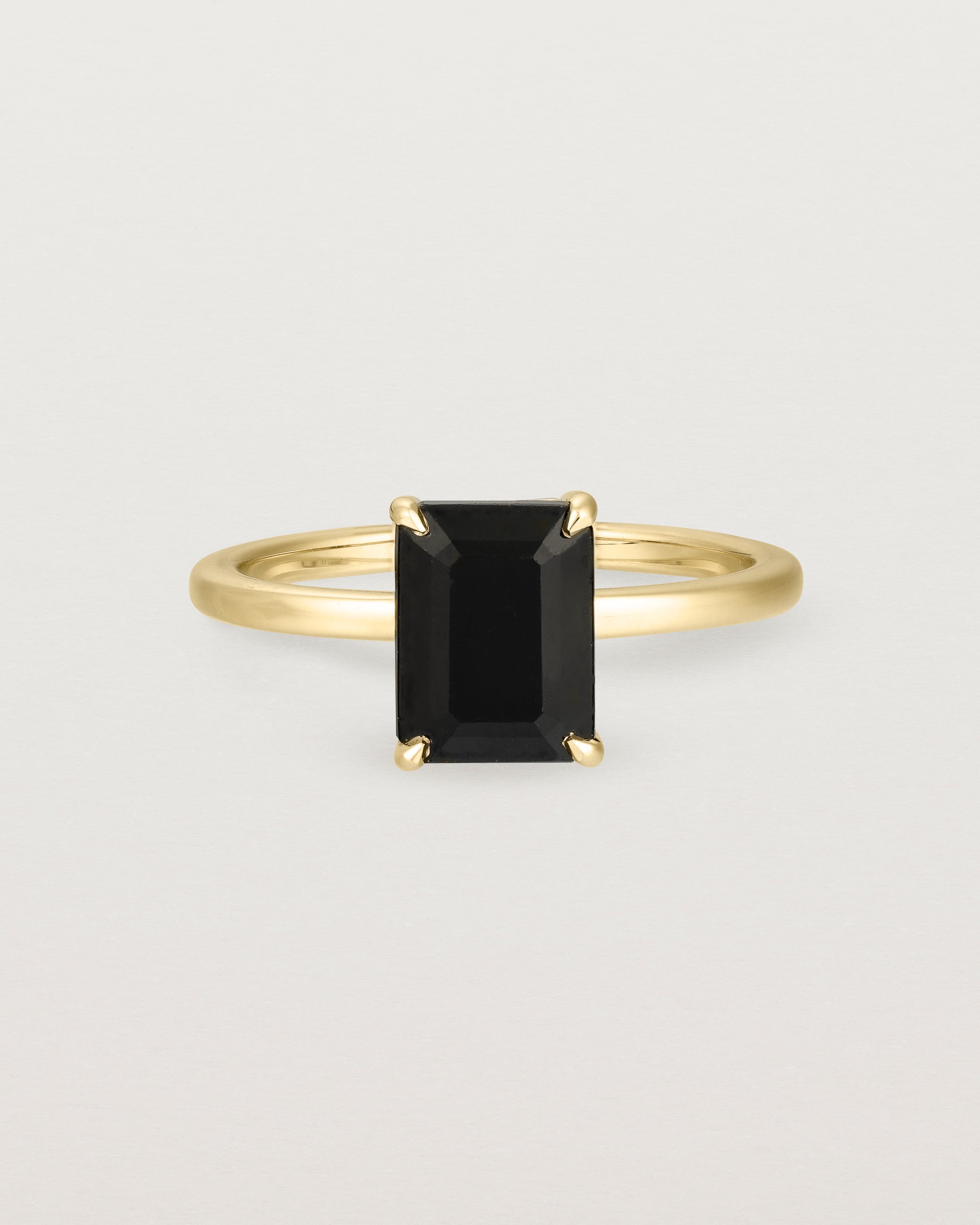Front view of the Una Emerald Solitaire | Black Spinel | Yellow Gold.