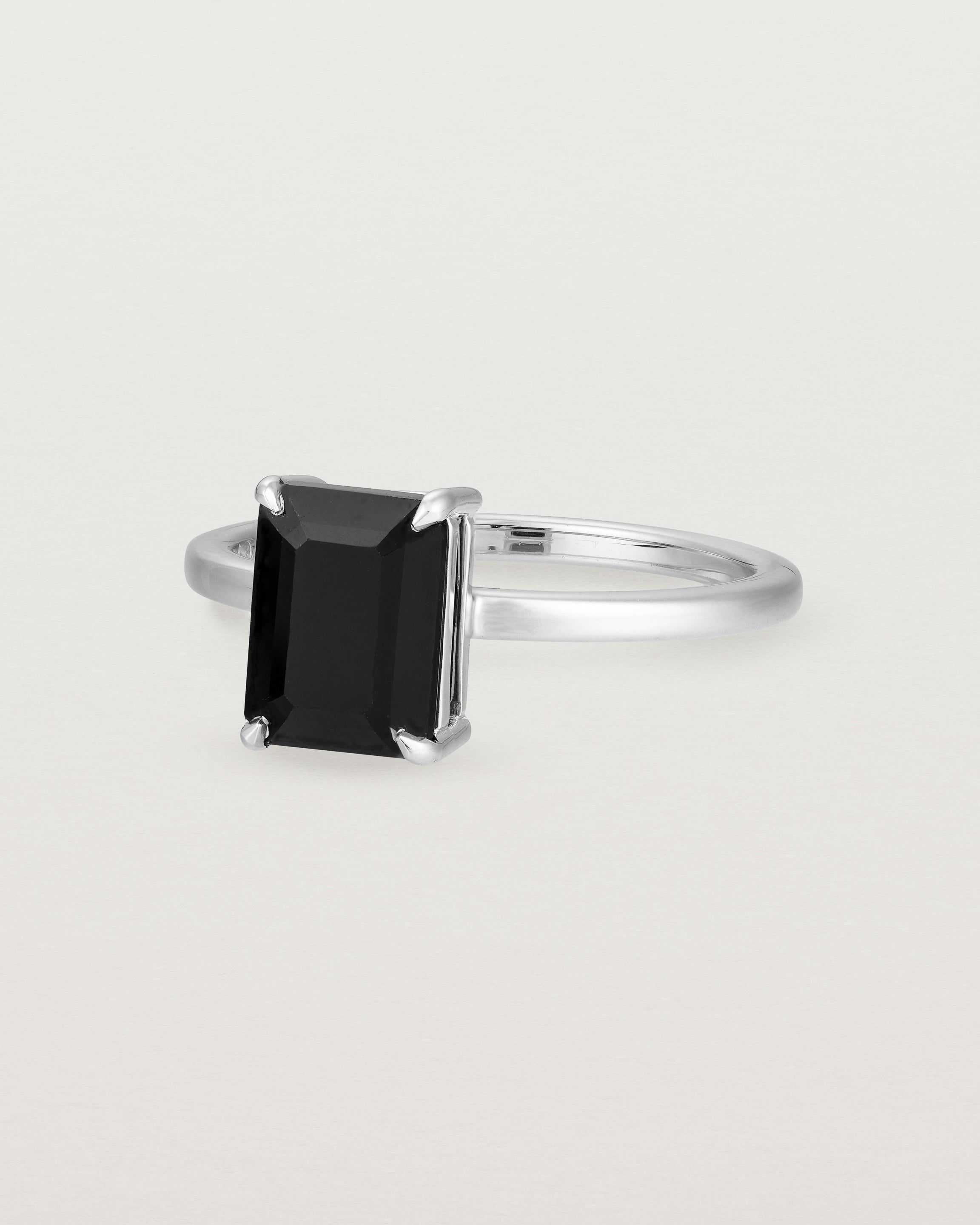 Angled view of the Una Emerald Solitaire | Black Spinel | White Gold.