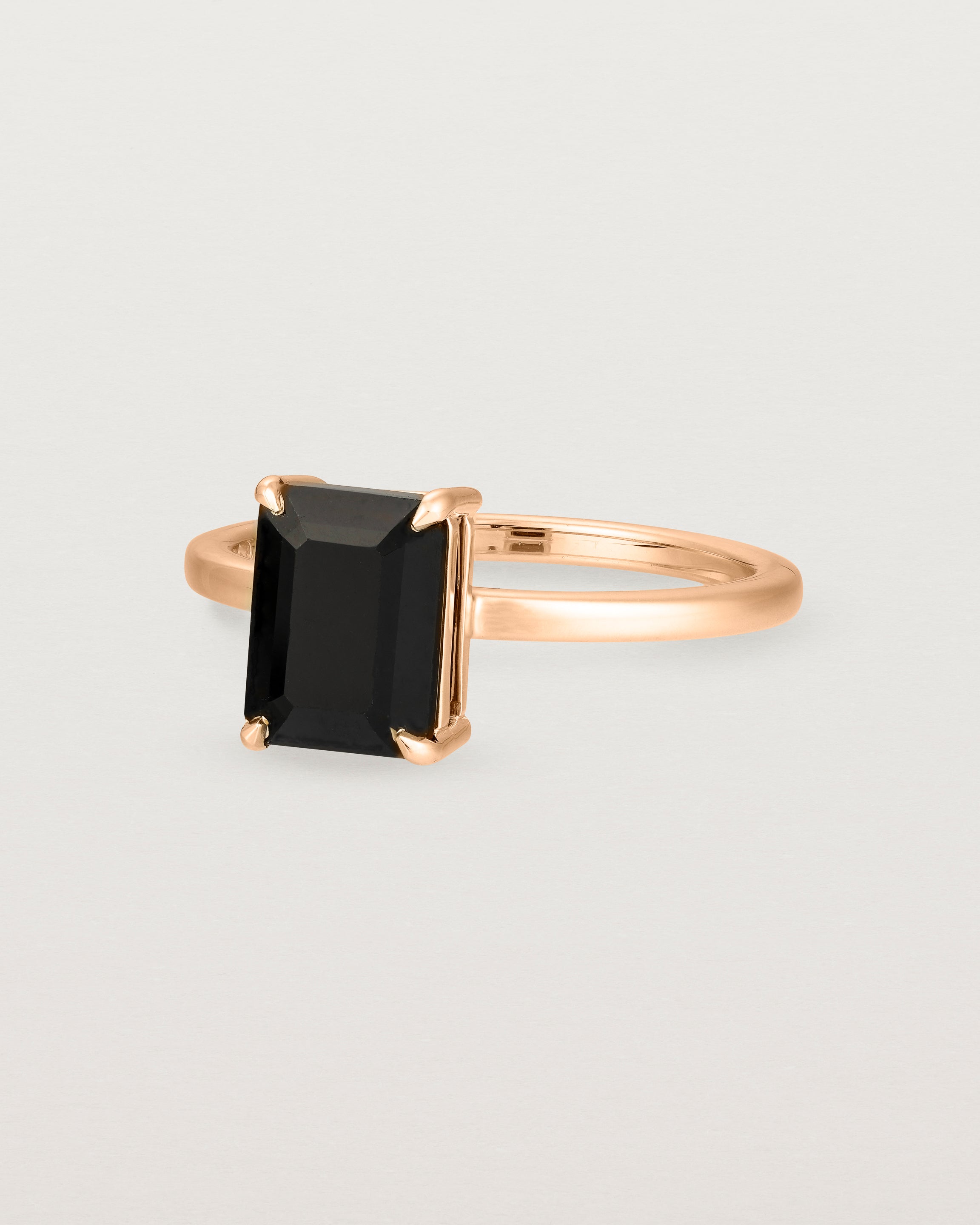 Angled view of the Una Emerald Solitaire | Black Spinel | Rose Gold.