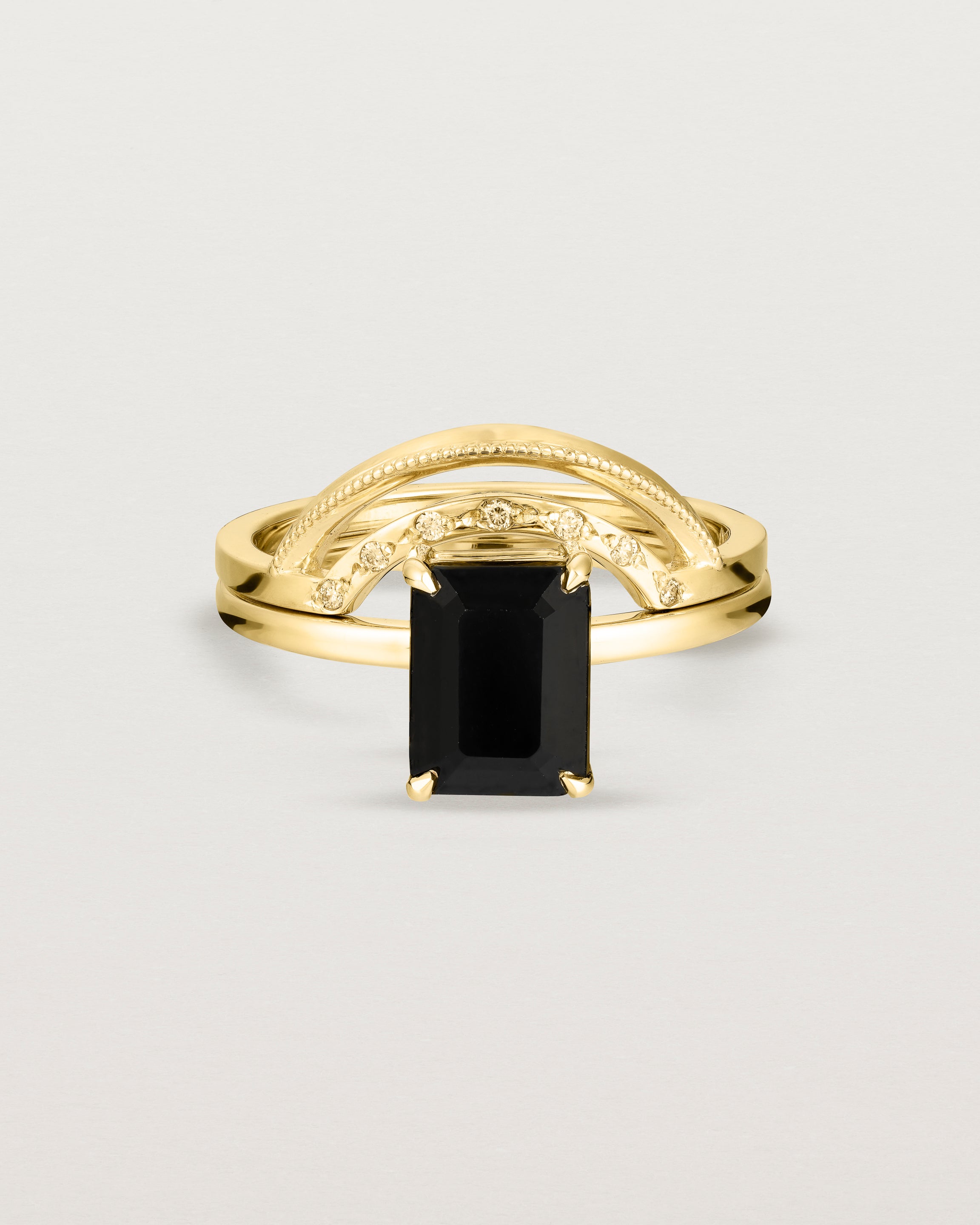 Front view of the Una Emerald Solitaire | Black Spinel | Yellow Gold stacked with the Evette Crown Ring.