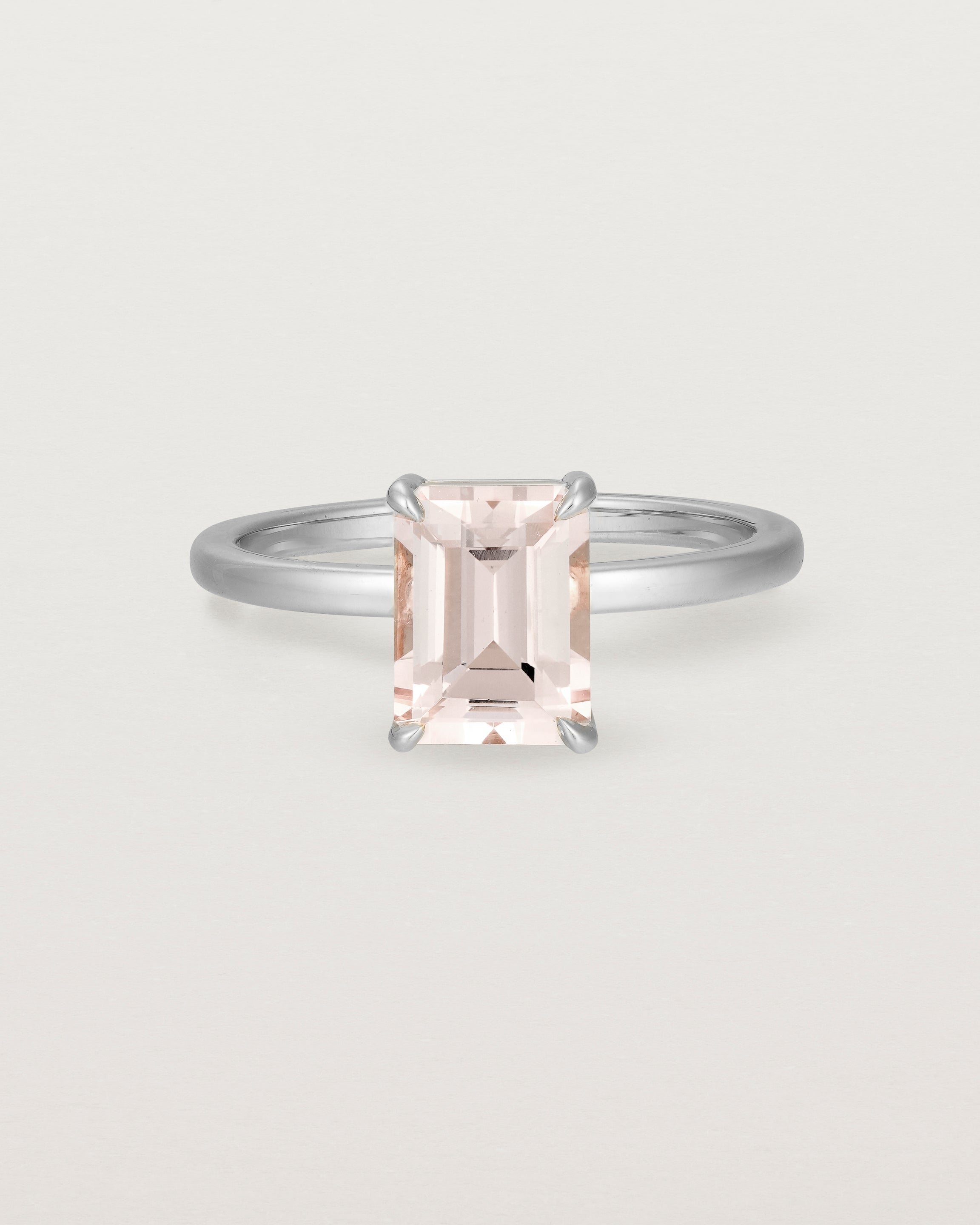 Front view of the Una Emerald Solitaire featuring a pale pink morganite