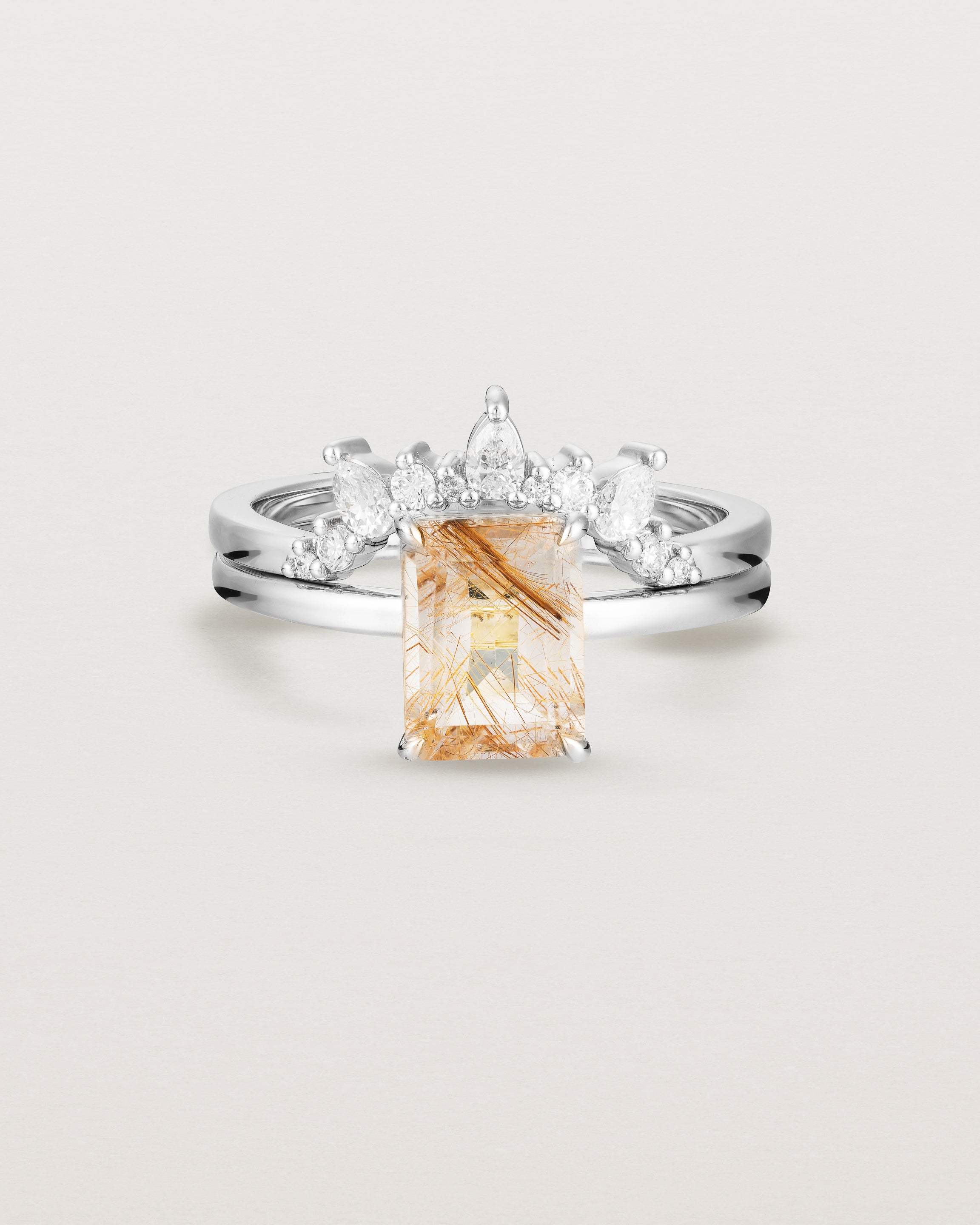 Front view of the Una Emerald Solitaire | Rutilated Quartz | White Gold stacked with the Odette Crown Ring | Diamonds.
