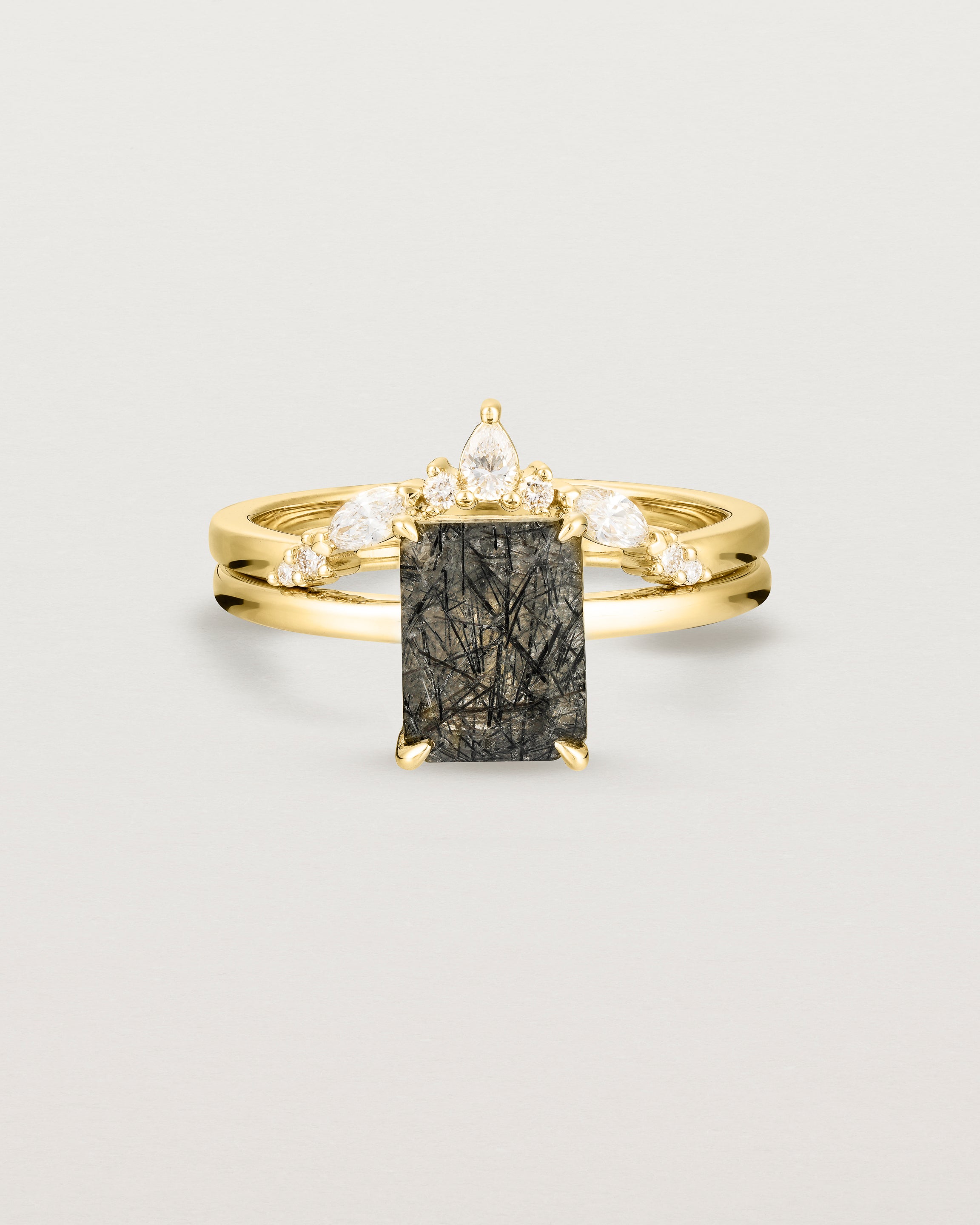 Front view of the Una Emerald Solitaire | Tourmalinated Quartz | Yellow Gold stacked with the Meia Crown Ring | Diamonds. 